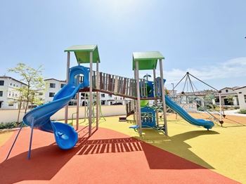 A playground with a blue and green slide.